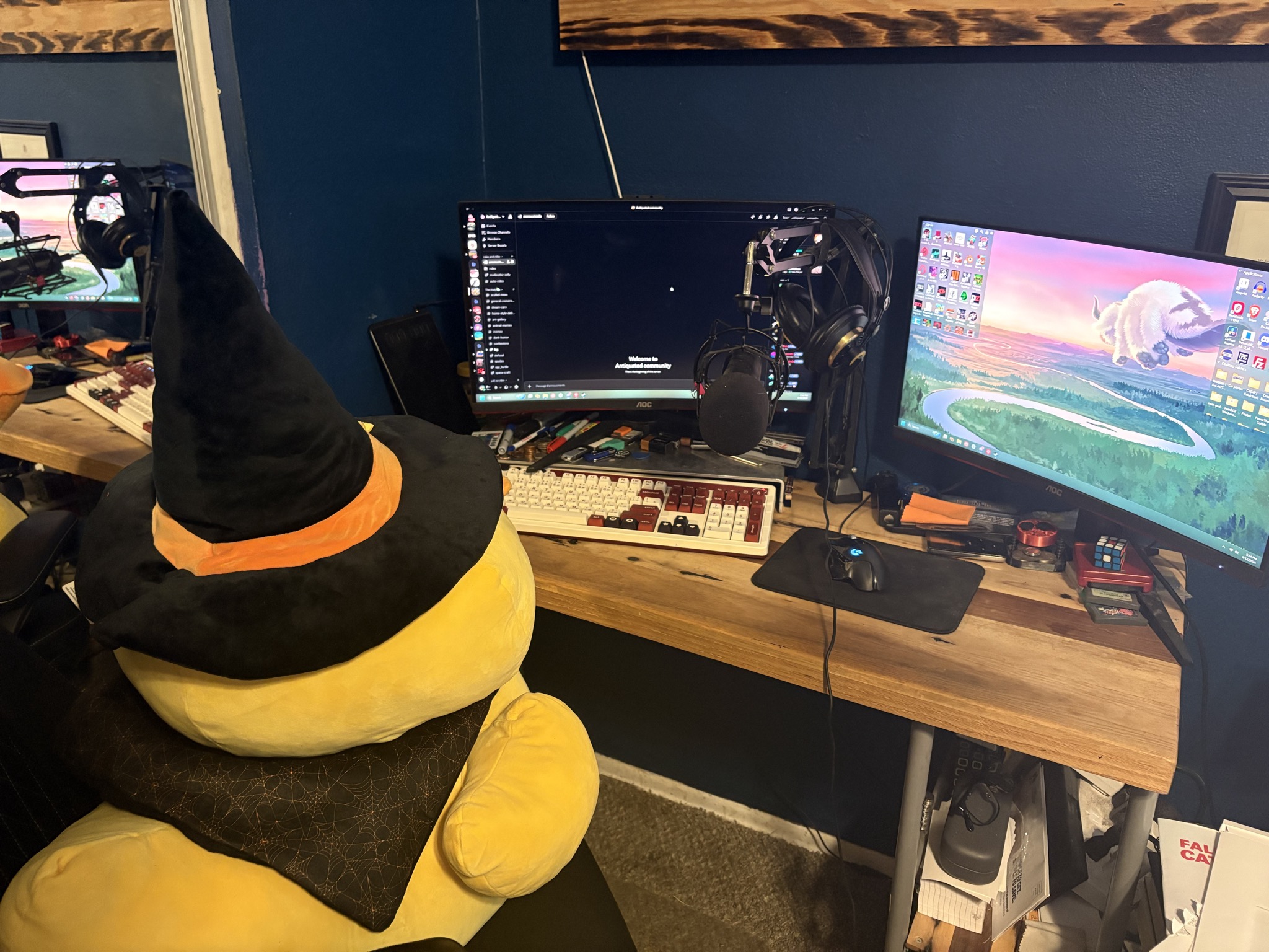 Justin's gaming setup with a large plush duck sitting in front of the monitor